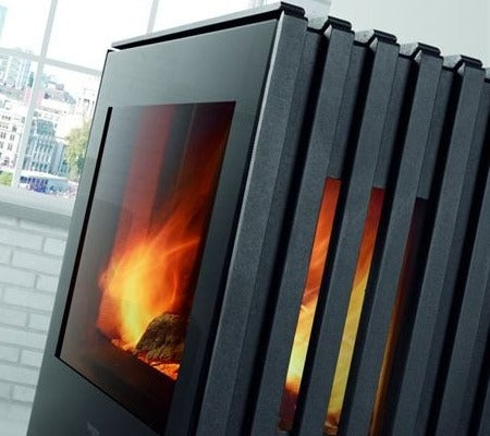 Castworks Hergóm Glance L wood fireplace with sleek glass front and modern design, suitable for cozy living rooms.