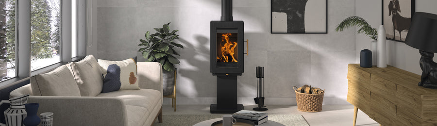 Castworks Hergóm Glow wood fireplace with a sleek, modern design and a glass front, showcasing a cozy fire burning inside.