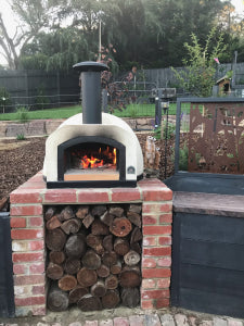 HVH70 Crema preassembled pizza oven from HVH Pizza Ovens, showcasing its compact design and pizza cooking surface.