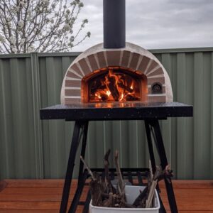 HVH70 Real Brick Preassembled Pizza Oven by HVH Pizza Ovens, showcasing its brick exterior and compact design for baking pizzas.
