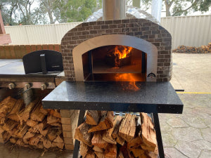 HVH70 Tiled Preassembled Pizza Oven by HVH Pizza Ovens, showcases the tiled exterior and compact design of the pizza oven.