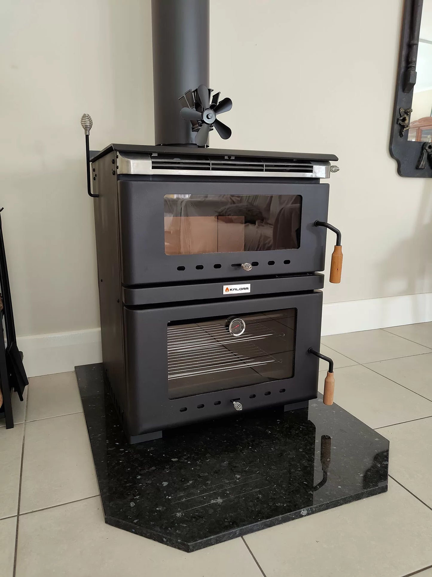 Kalora Fusion stove style fireplace with wood storage and fire burning