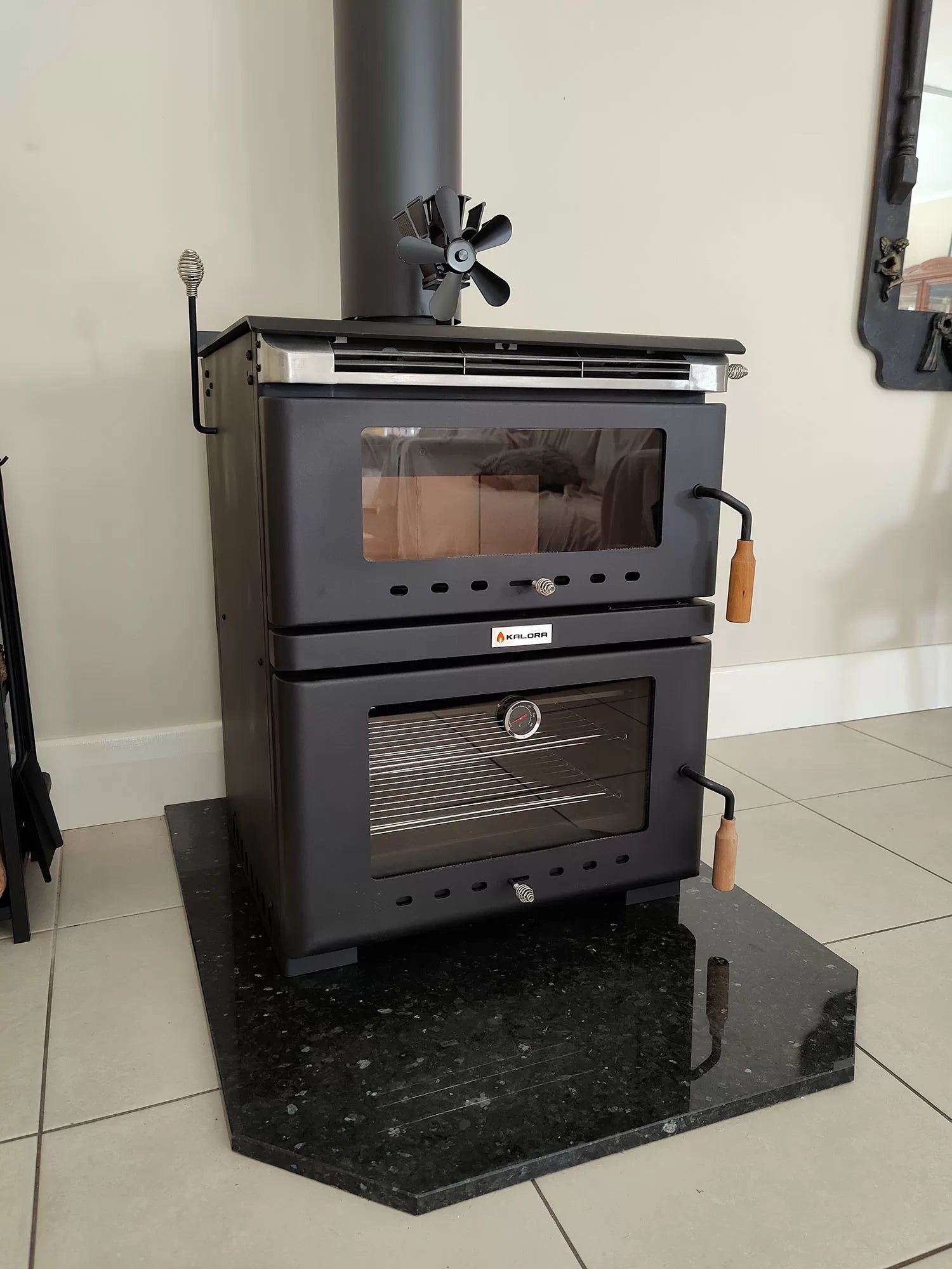 Kalora Fusion stove style fireplace with wood storage and fire burning