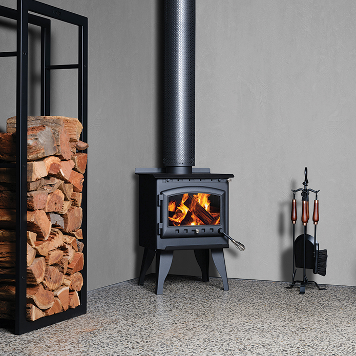 Kalora 425R wood heater with fire burning and wood storage base