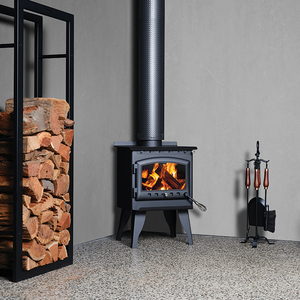 Kalora 425R wood heater with fire burning and wood storage base