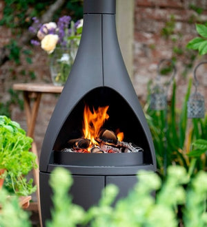 Morsø Kamino outdoor fireplace and oven with sleek metal design and chimney for outdoor cooking and warmth.