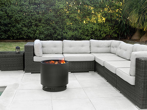 Stainless steel VisionLINE Outdoor Firepit with fire bowl and decorative exterior for outdoor fireplaces and gatherings.